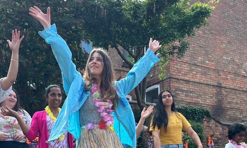 Broadgate Care Home staff performing a lively Hawaiian-themed dance for residents.