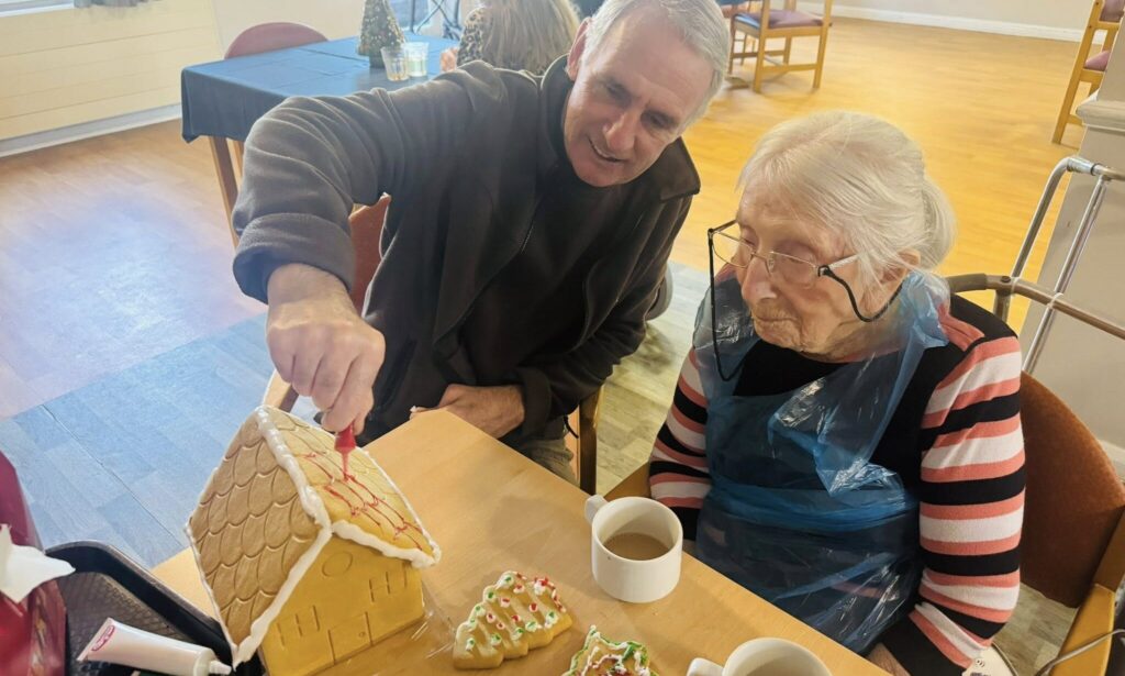 Grenville Court residents engaged in making gingerbread House