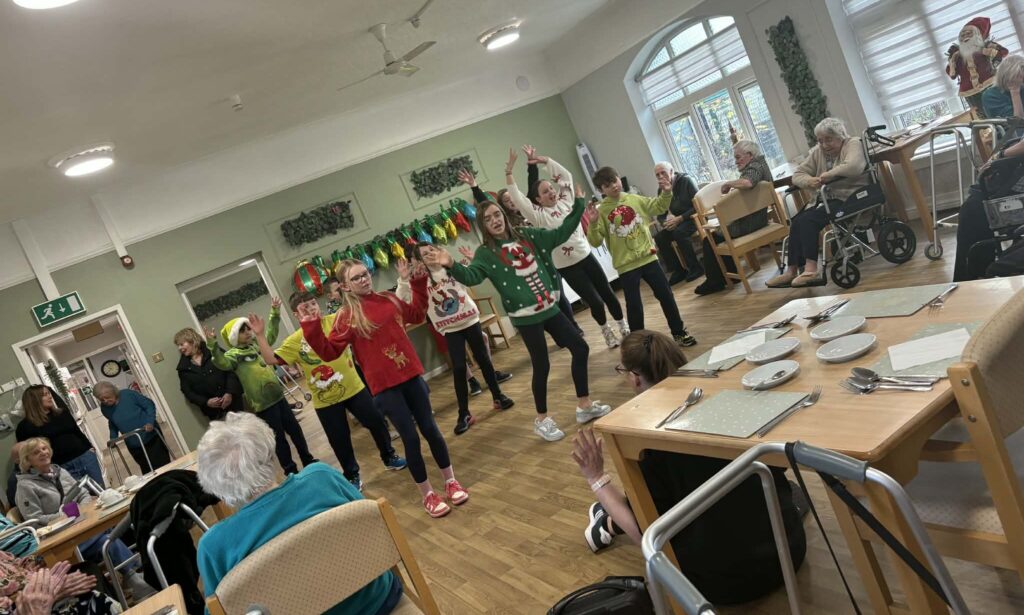 Hourigan House residents enjoying dance performance by the primary school students