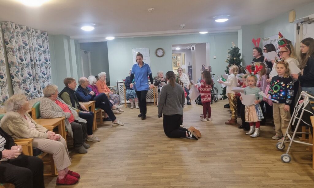 Leycester House care home residents enjoying carols from the kids of Rainbow