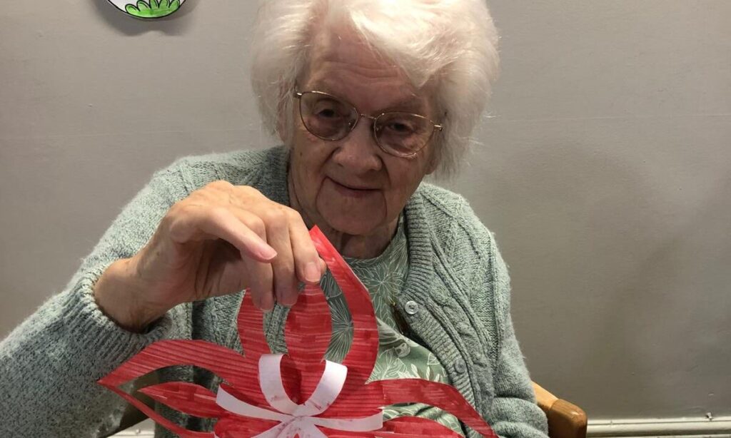 Redhill Resident holding a hand made Christmas Craft