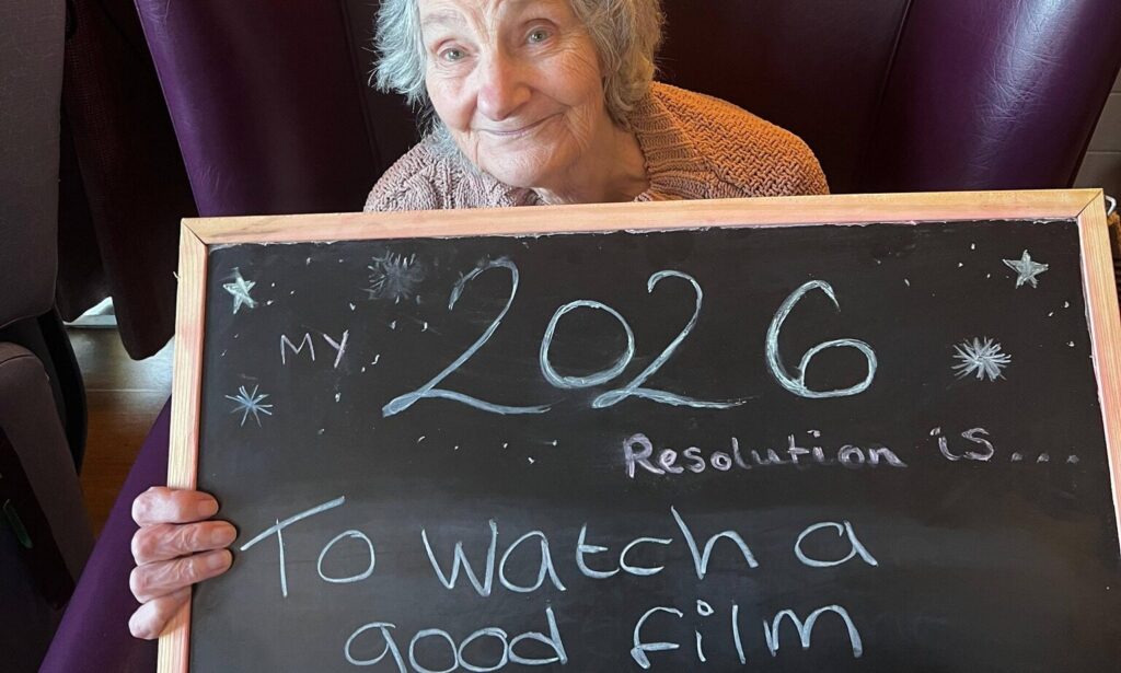 Waterside Resident holding a board with 2026 resolution