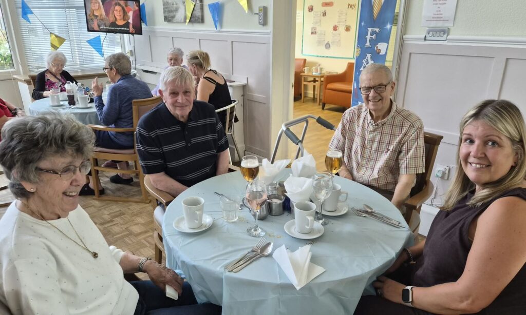 Residents singing and dancing to classic songs on Father's Day at Garswood House