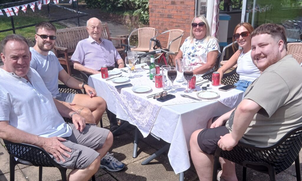 Resident Derek enjoying lunch by the Holcroft Sundial Bar on Father's Day at Holcroft Grange