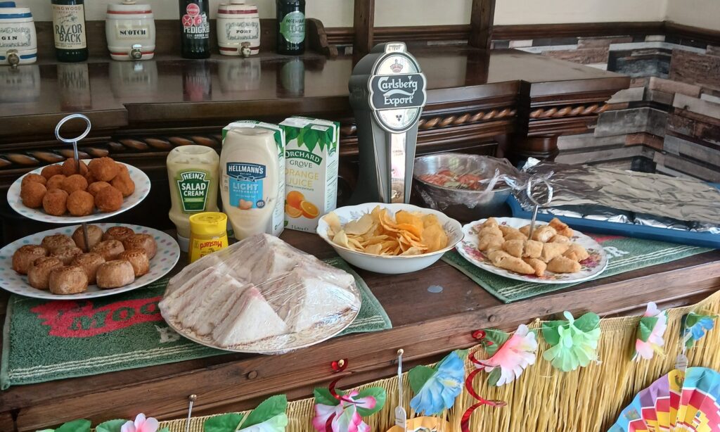 Residents and family enjoying an outdoor Father's Day celebration at Holcroft Grange